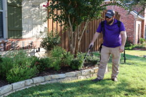 Tactical Pest Expert spraying the exterior of a home